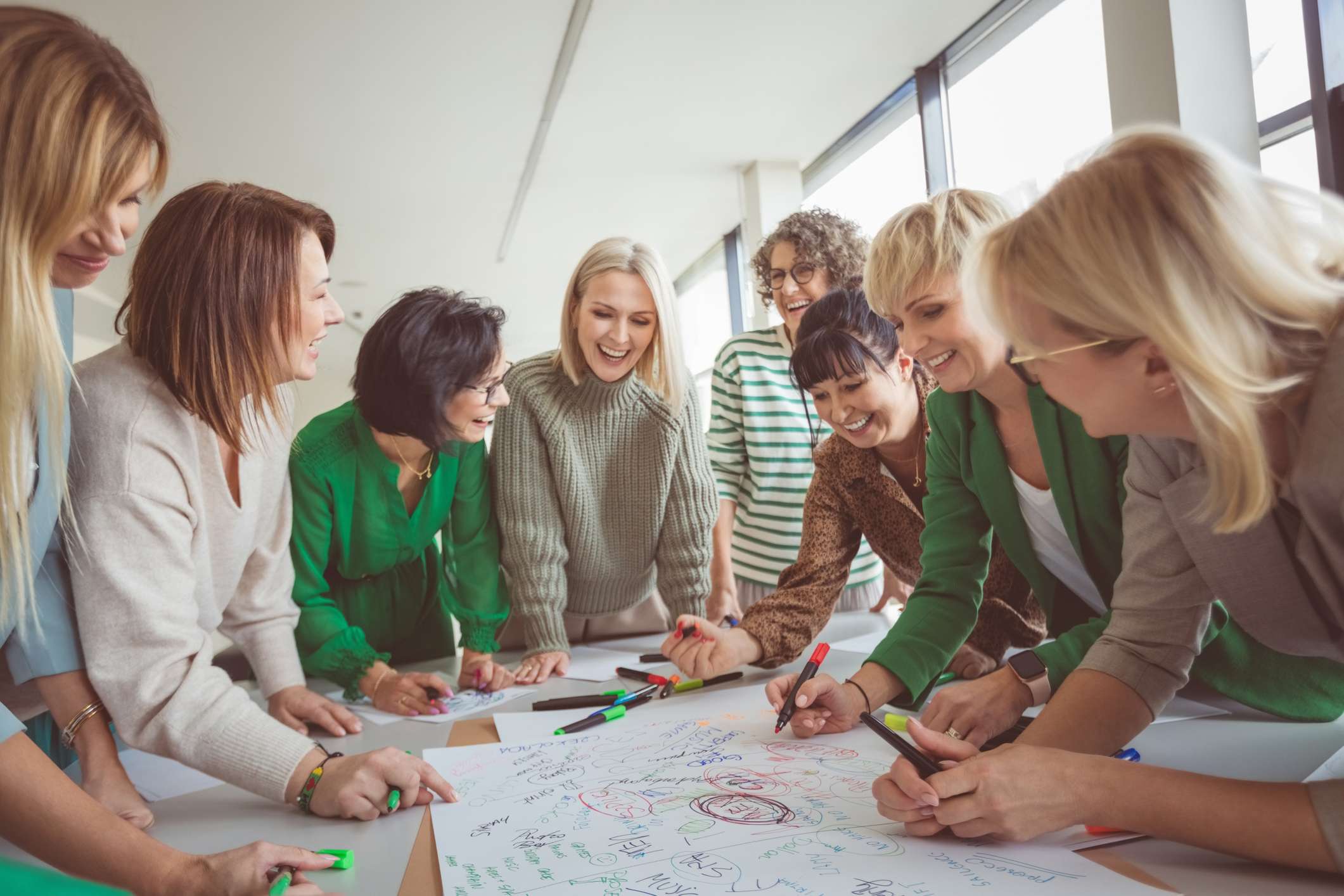 Women colleagues working together around a table